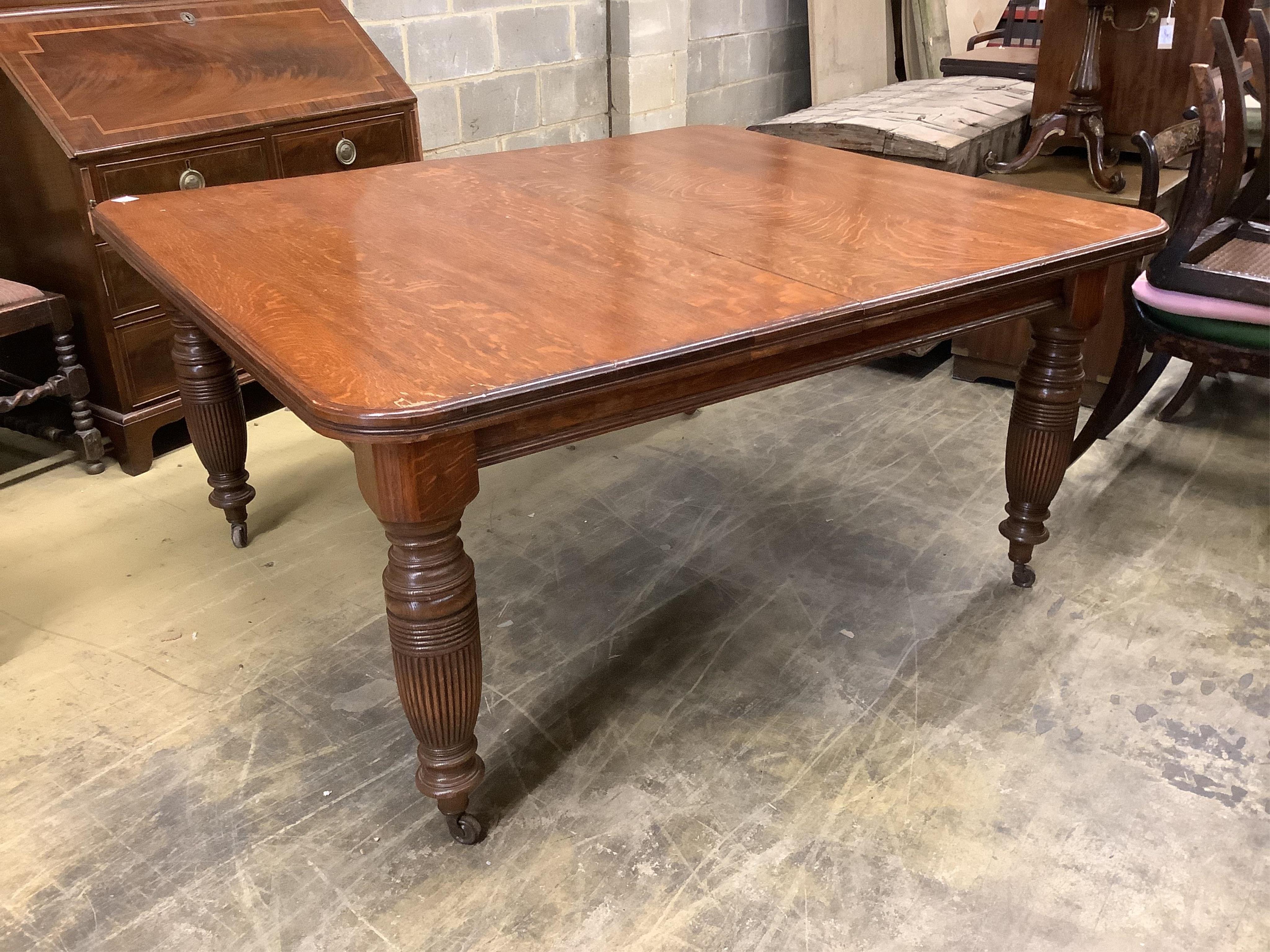 A late Victorian oak extending dining table, with three spare leaves, width 290cm extended, depth 135cm, height 74cm. Condition - fair